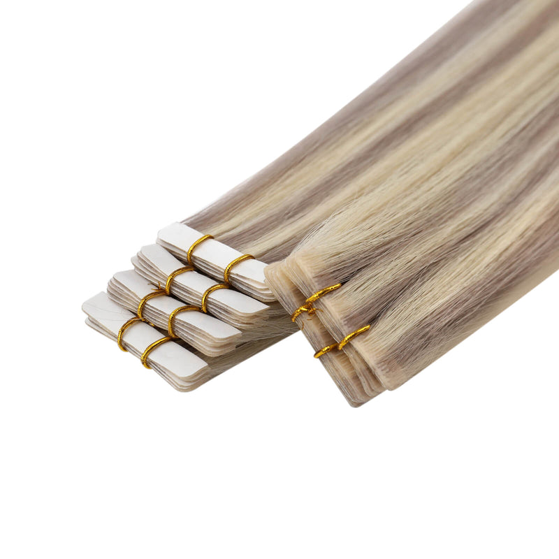 Load image into Gallery viewer, A bundle of invisible tape in hair extensions with a light ash blonde and brown ombré color
