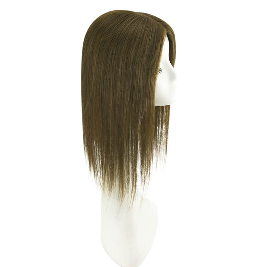 Brown hair topper on a mannequin head against a white background