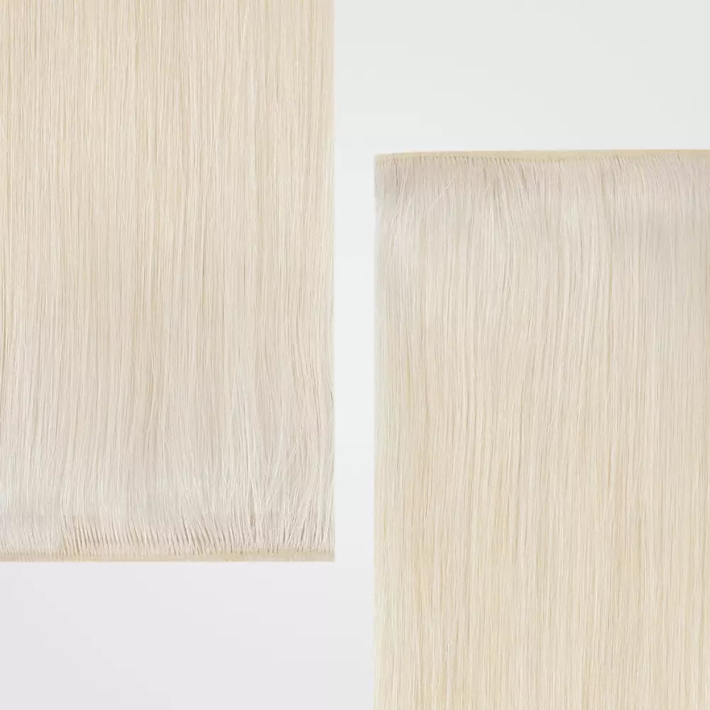 Two strands of blonde hair extensions on a white background