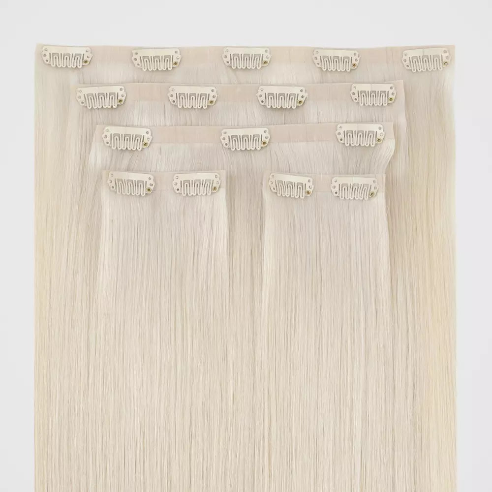 Set of blonde genius clip in hair extensions on a white background
