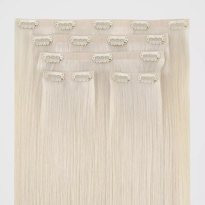 Load image into Gallery viewer, Set of blonde genius clip in hair extensions on a white background
