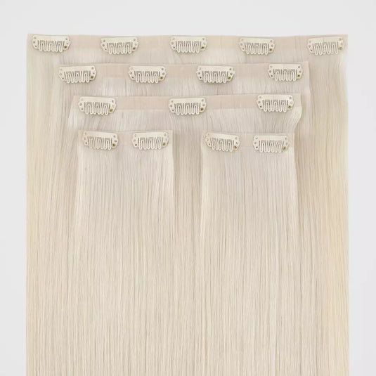 Set of blonde genius clip in hair extensions on a white background