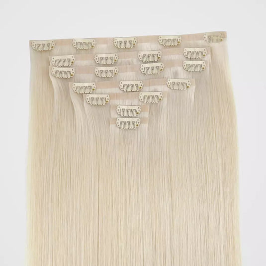 Remy clip in hair extensions on a white background