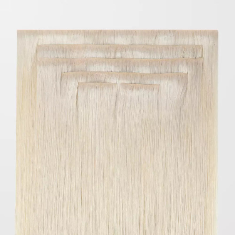 Load image into Gallery viewer, Set of blonde invisible clip in hair extensions on a white background
