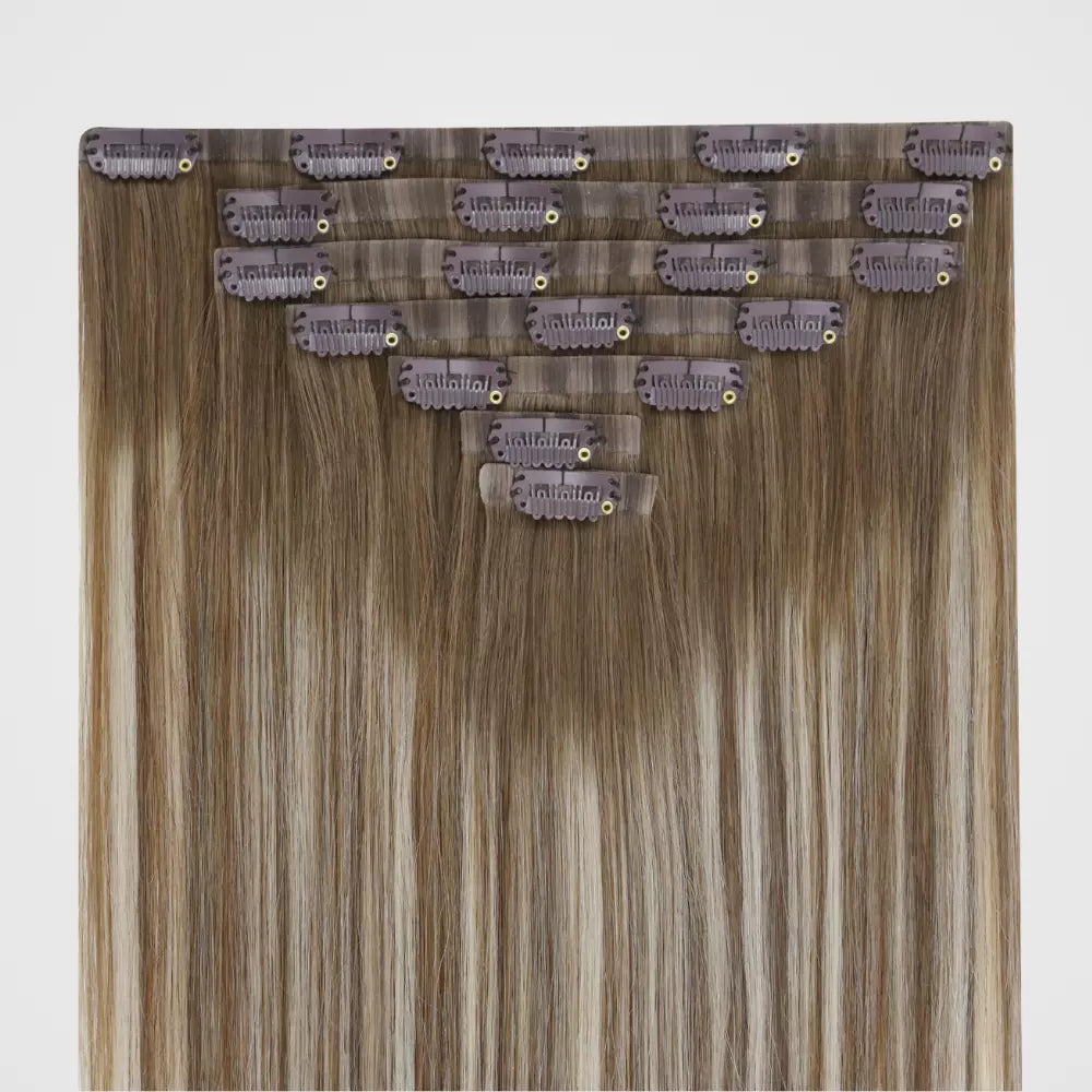 Set of invisible clip hair extensions with clips on a light gray background
