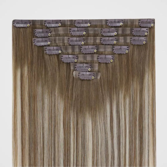 Set of invisible clip hair extensions with clips on a light gray background