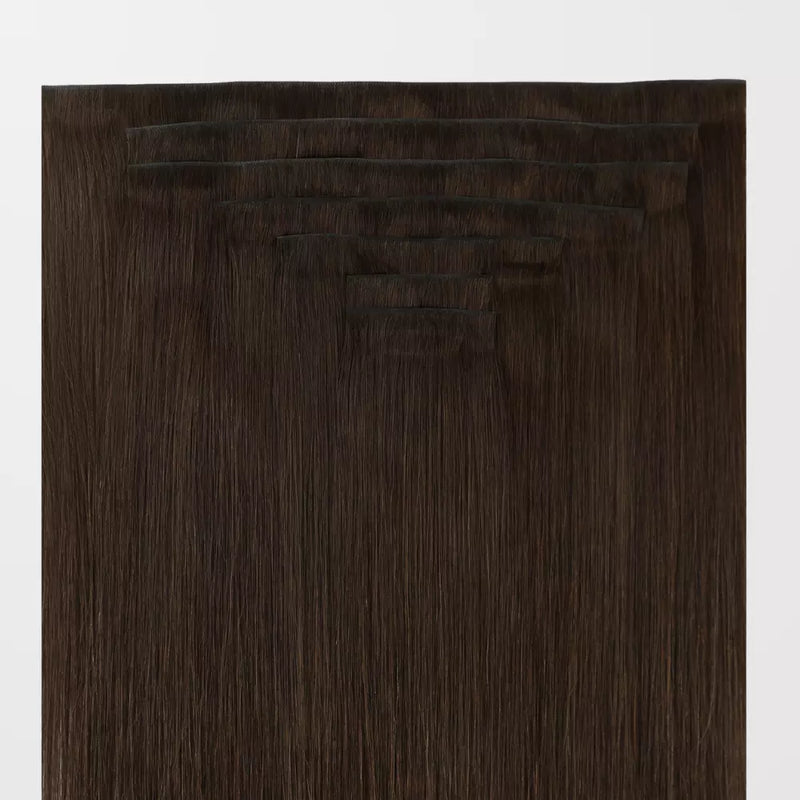 Load image into Gallery viewer, Set of brown clip hair extensions on a white background
