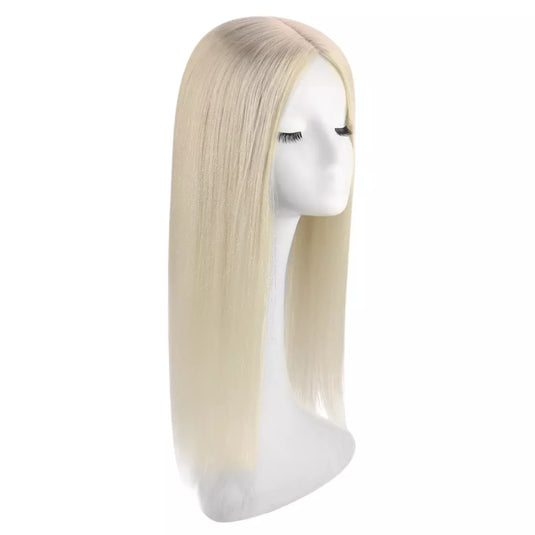 Blonde hair topper on a mannequin head against a white background