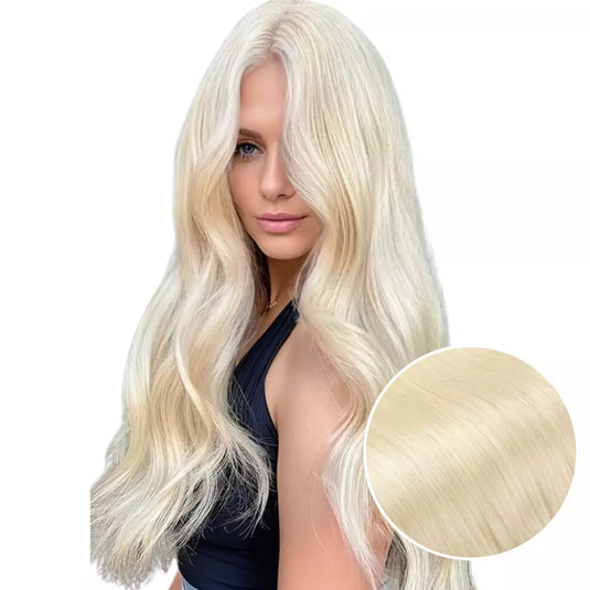 Model with long, blonde keratin hair extensions on a white background