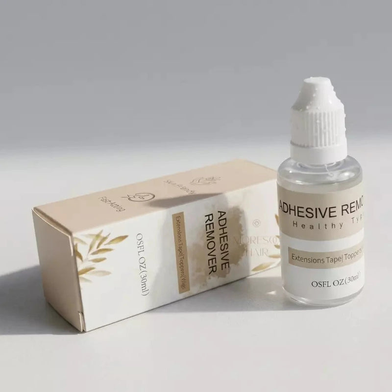 Load image into Gallery viewer, Adhesive remover bottle and box on a gray background
