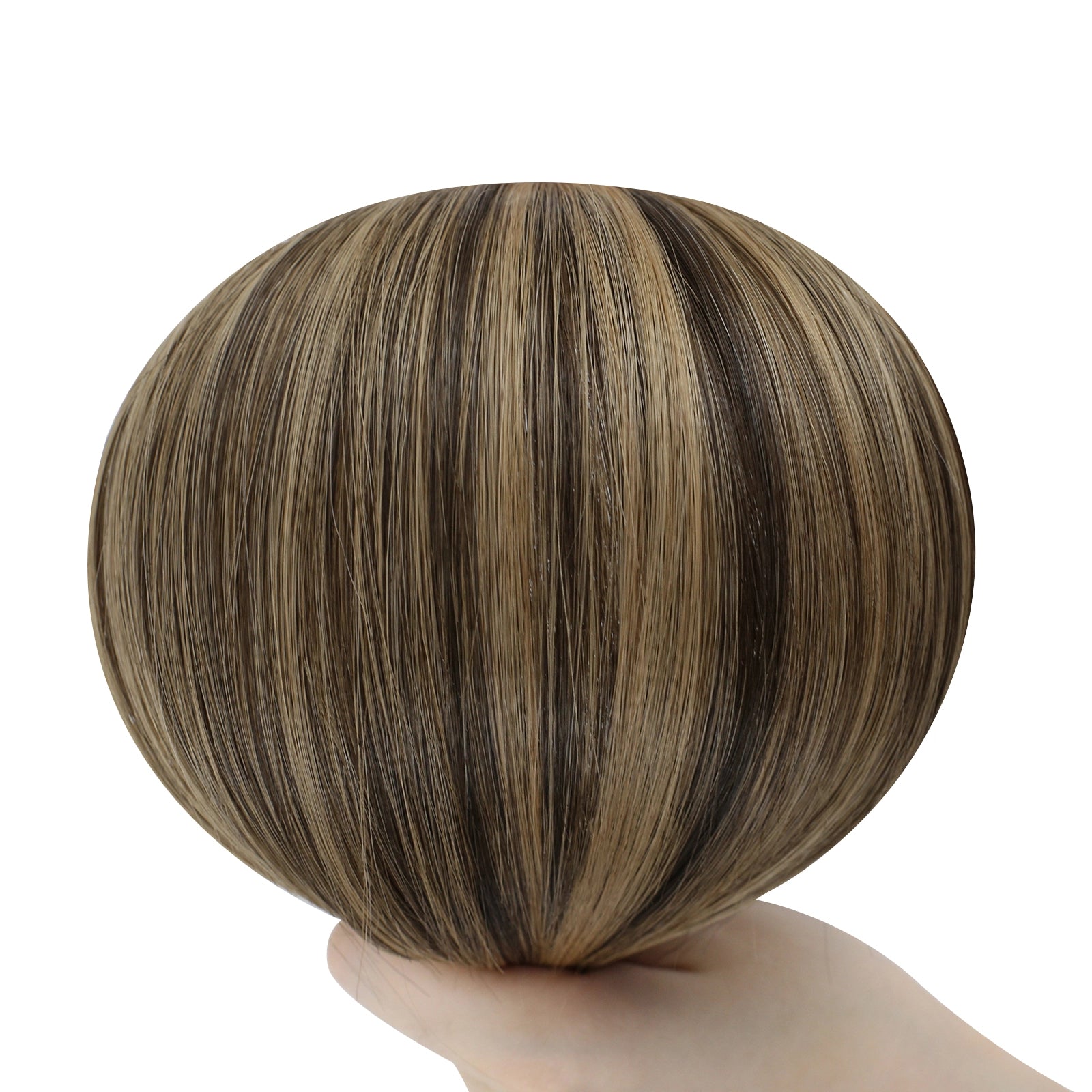Brown and blonde hair bun held by a hand on a white background