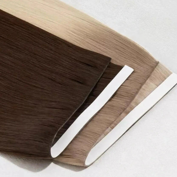 Two hair extensions, one brown and one beige, on a white background.