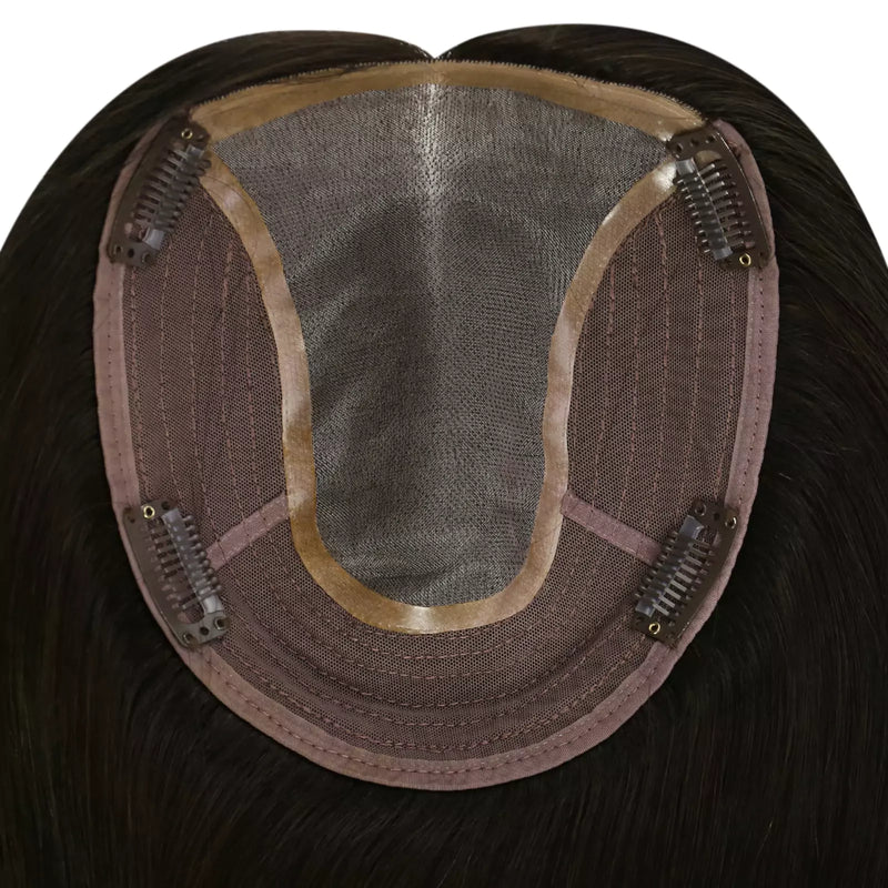 Load image into Gallery viewer, Close-up of the underside of a hairpiece extension, showing a semi-sheer mesh crown, brown adhesive base, and multiple metal hair clips holding the piece in place. T
