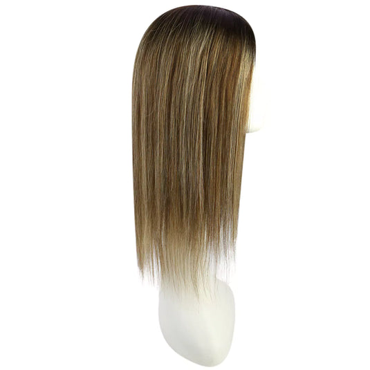 A straight, shoulder-length topper with a balayage brown color, displayed on a white mannequin head against a plain white background.