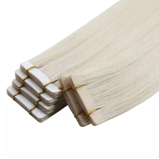 Stack of blonde hair extensions on a white background
